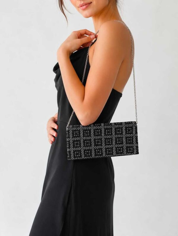 A handcrafted black tally bag with silver-coated thread embroidery and a metallic silver handle, made by the women artisans of Sohag. Size: 25x12 cm.